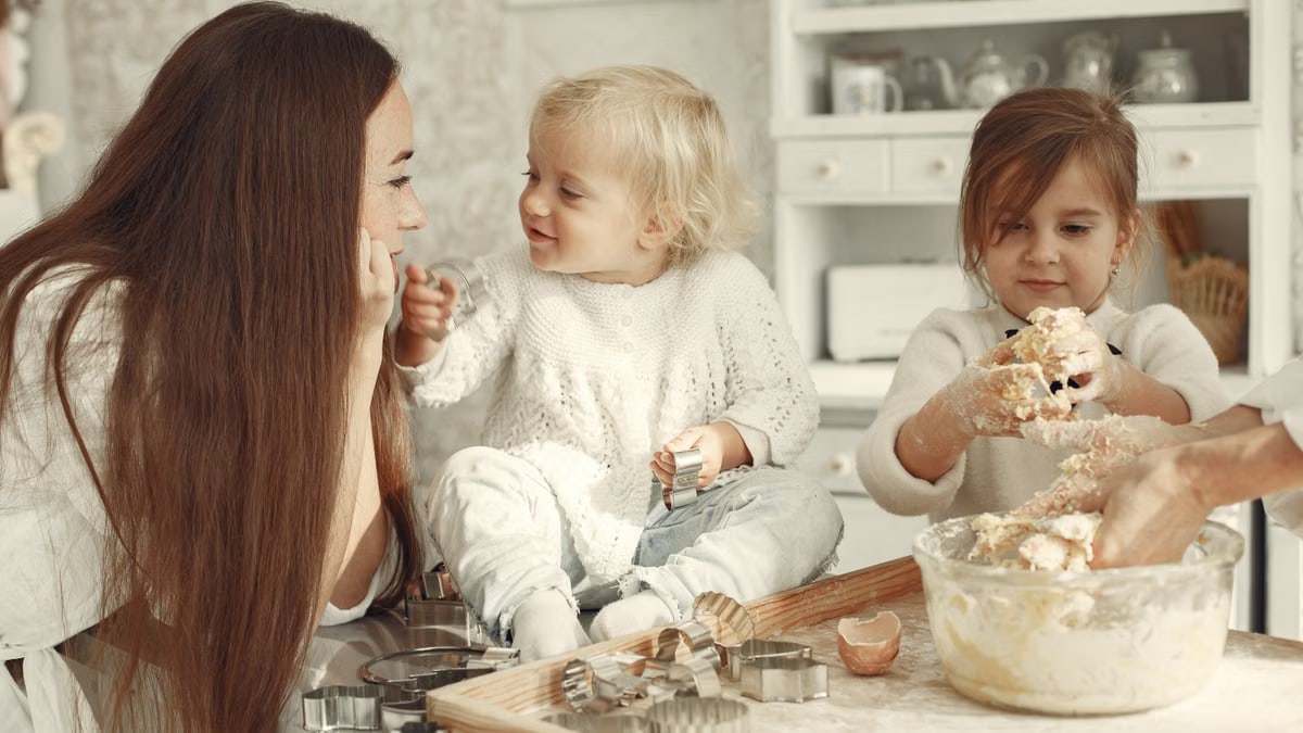 Happy family bonding while baking cookies in a cozy kitchen setting.